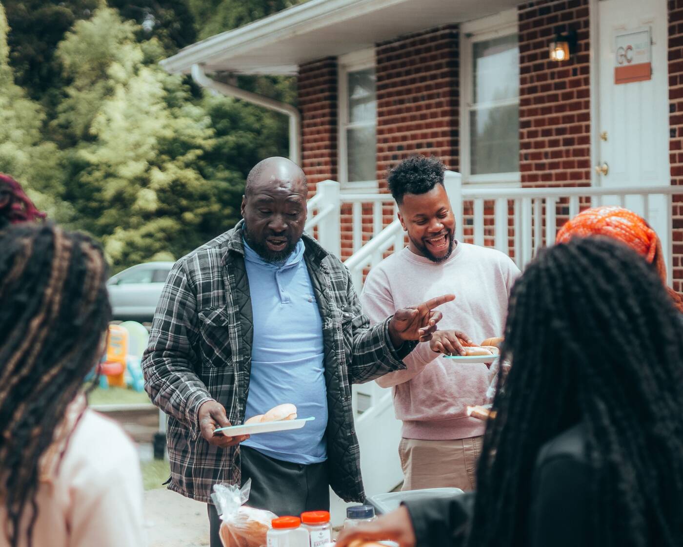 Friends and support staff gathering outside a residence